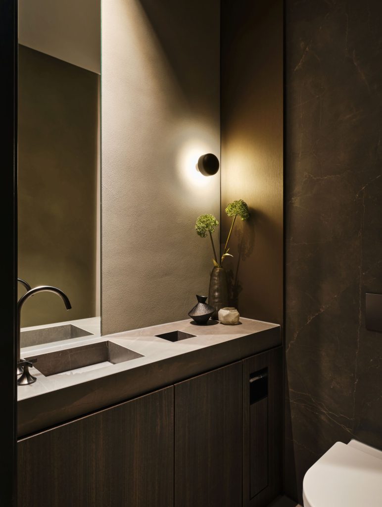 Maatwerk toiletmeubel met geïntegreerde wastafel, Decolegno houtafwerking en luxe wandbekleding in een woonboerderij in Roden, ontworpen door DUIN Interior en gerealiseerd door A&F Interieurbouw.